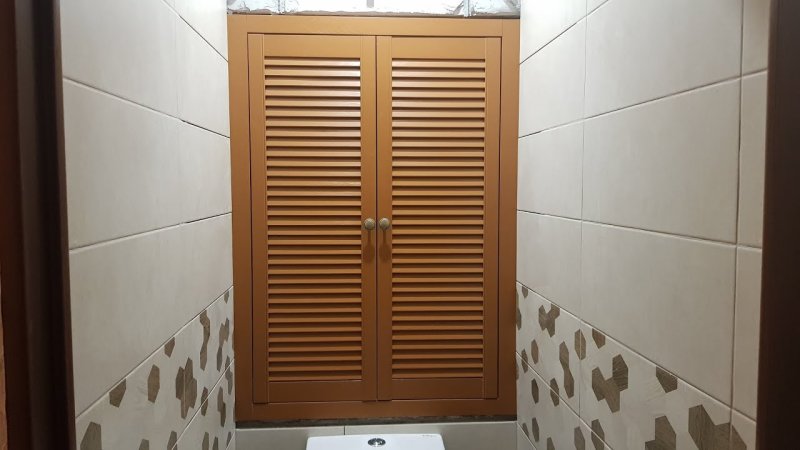 Wooden door to a plumbing closet