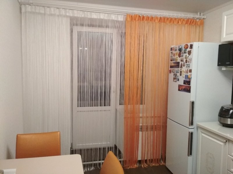 Thread curtains in the interior of the kitchen