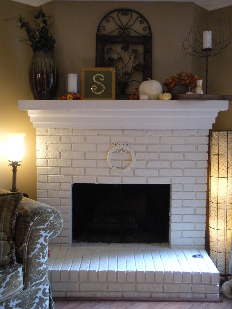 The fireplace is white brick