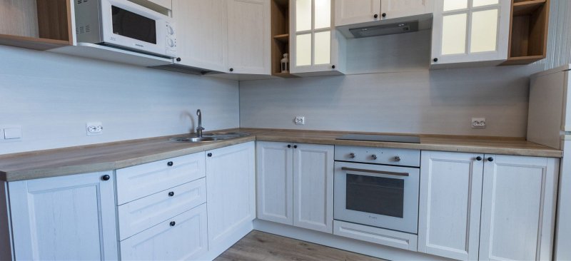 White kitchen with a tabletop under a tree