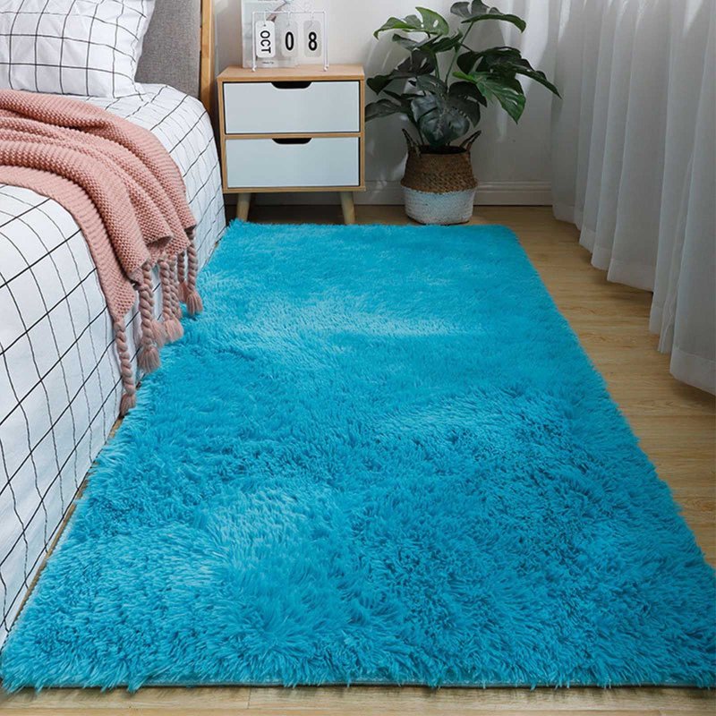 The bedside rug is plain