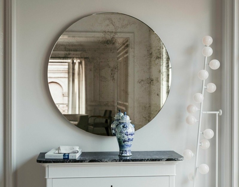 Round mirror in the bathroom in the interior