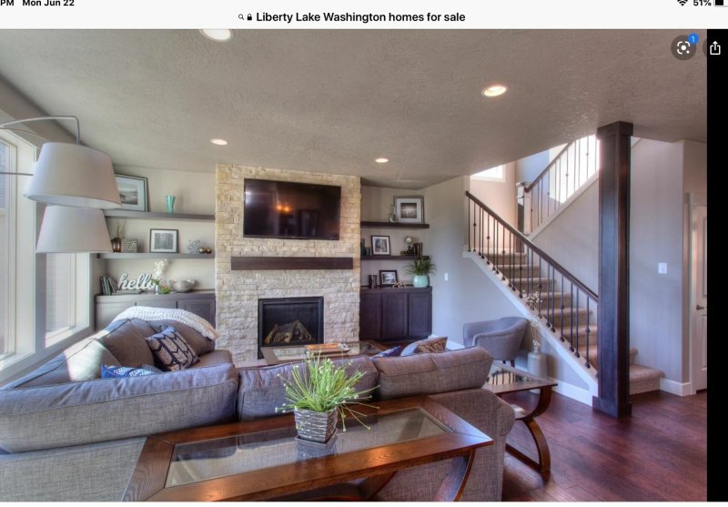 Living room with a staircase and fireplace