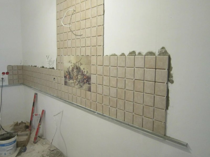 Laying tiles on the apron of the kitchen