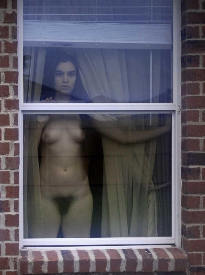 Naked women in the windows of houses