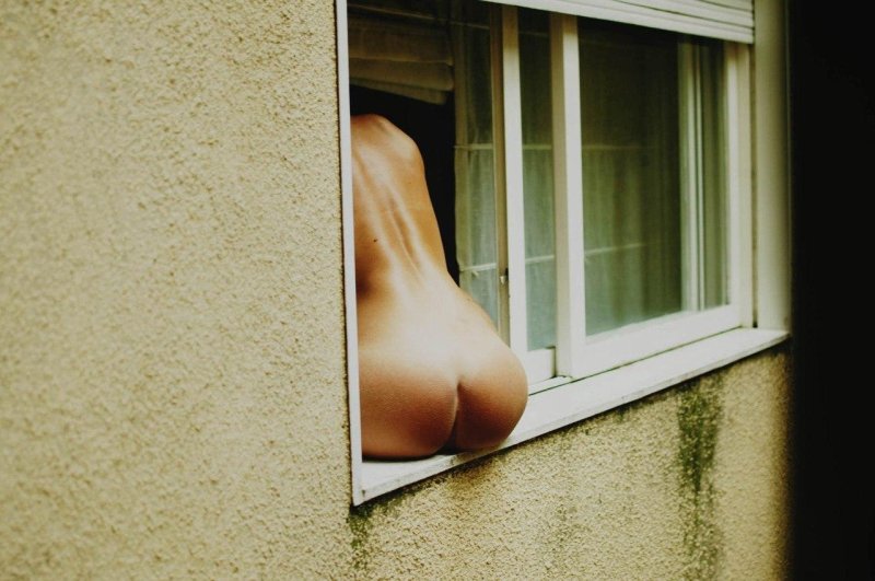Naked women in the windows of houses
