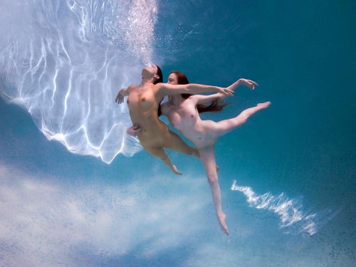 Naked girls jump into water