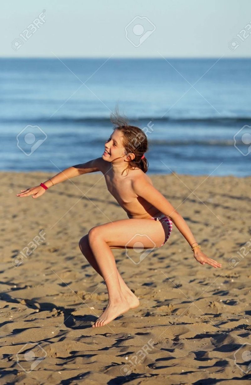 A ten -year -old girl in swimsuit at sea