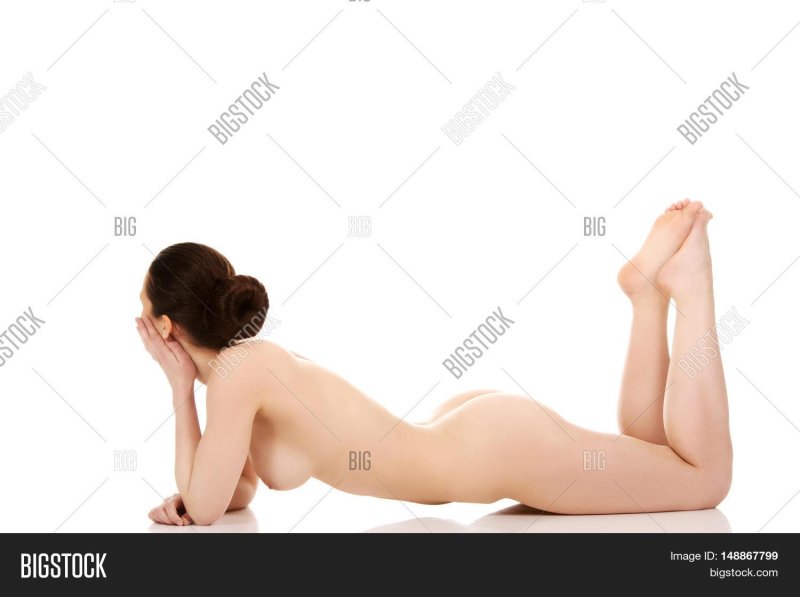 Naked woman lies on top of stock