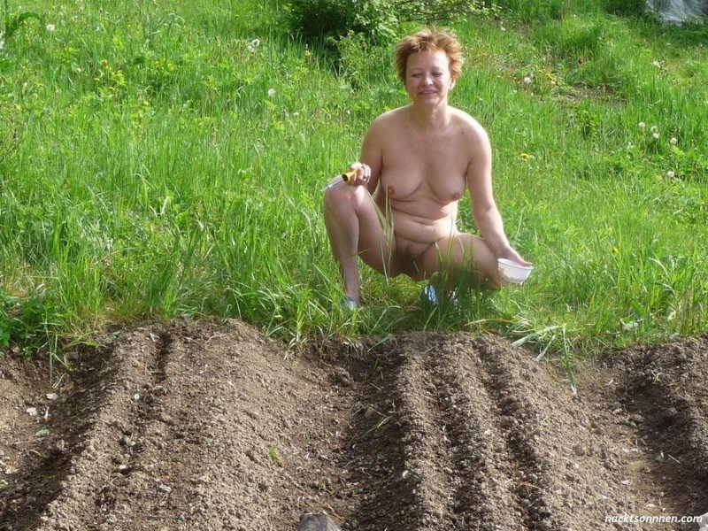 Naked wife in the country garden