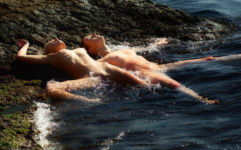 Girl swimming in the sea naked