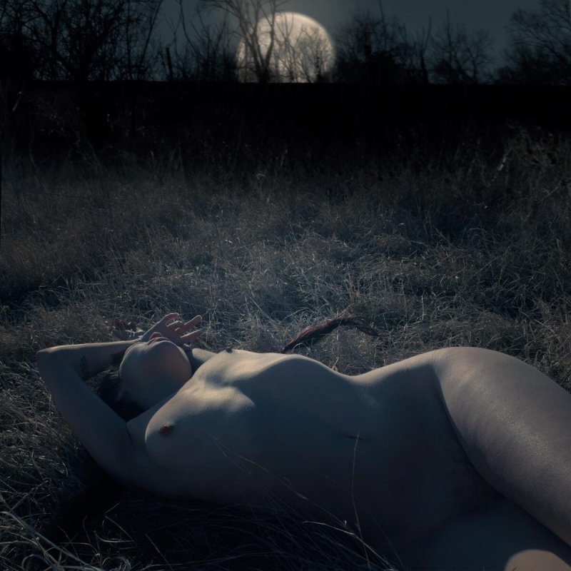 Photoshoot of nude in a night forest