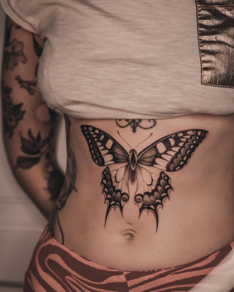 Butterfly tattoo under the chest