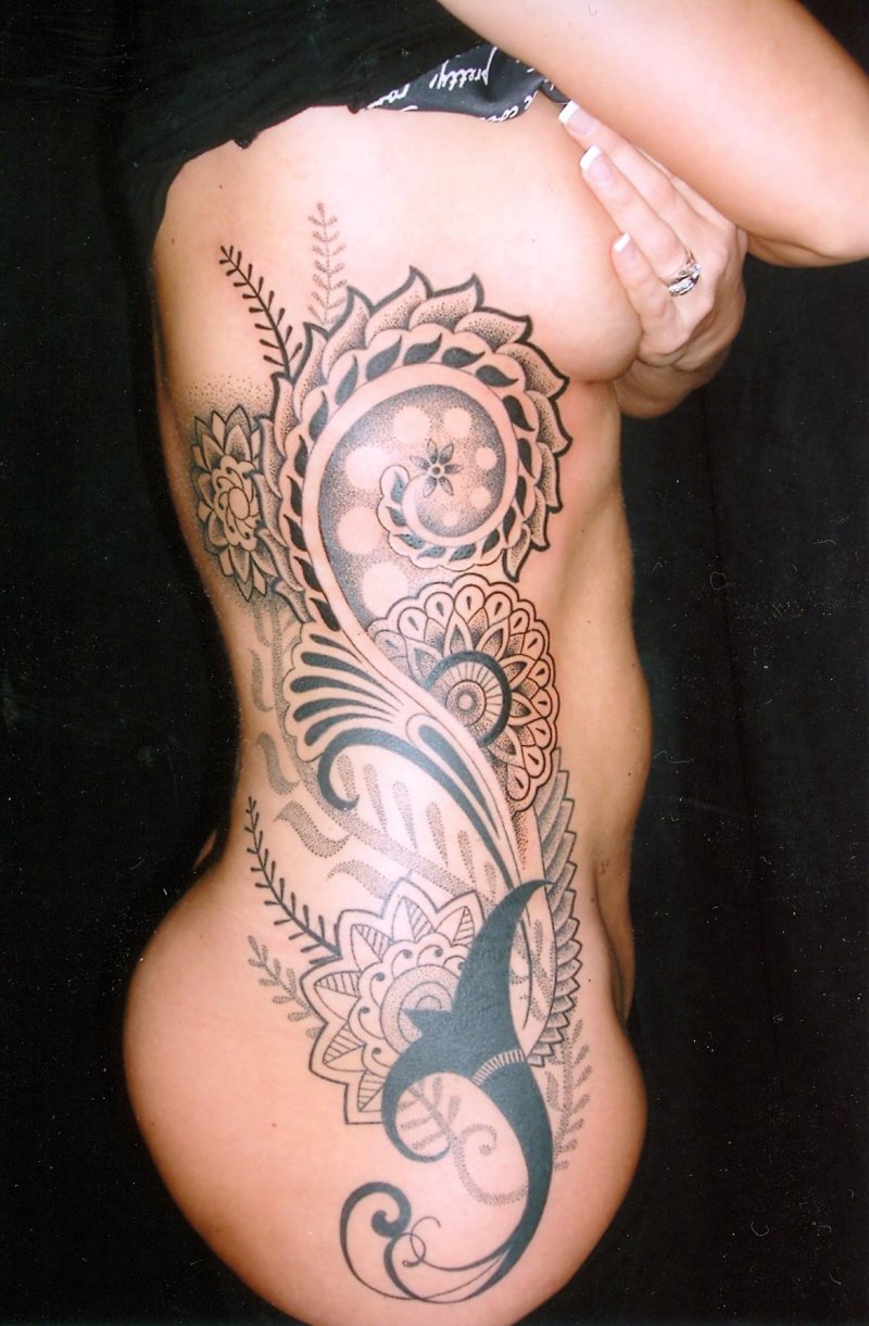 Polynesia tattoo on the side of women