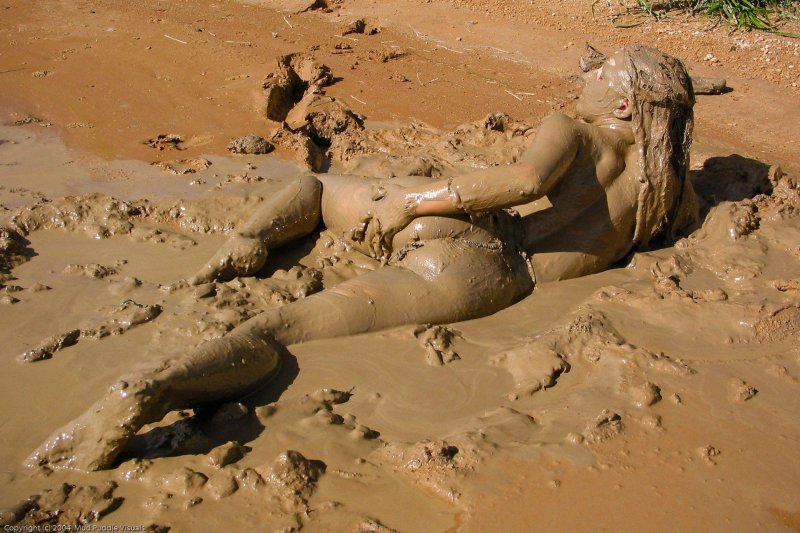 Women swim in the mud