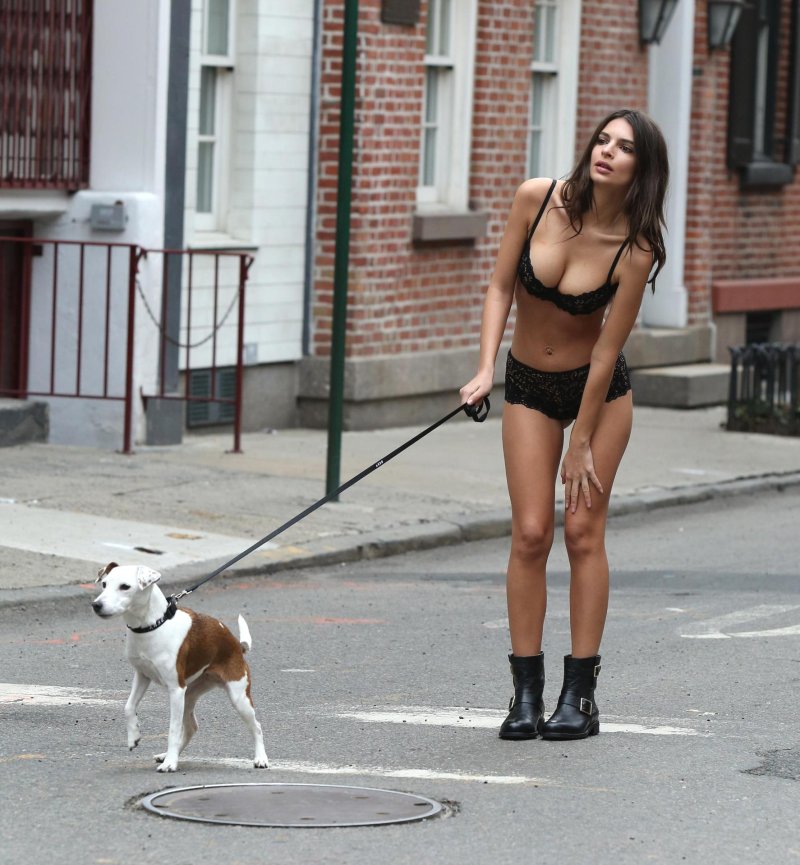 Emily Ratazhkovsky walks with a dog in underwear