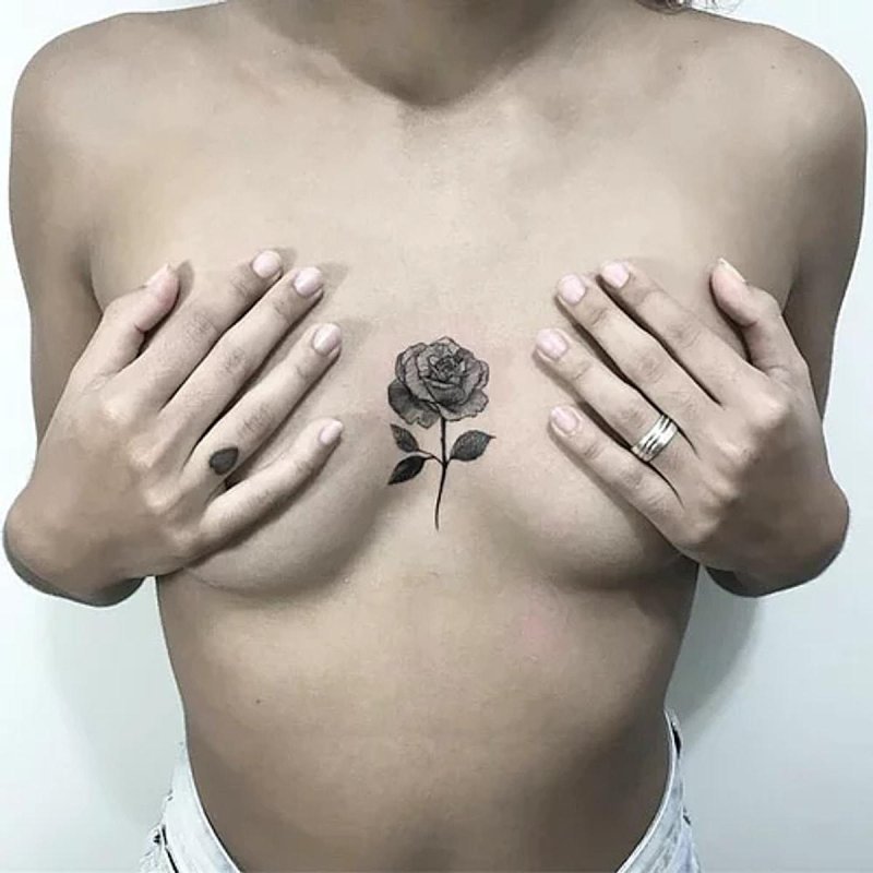 Rose tattoo between breasts