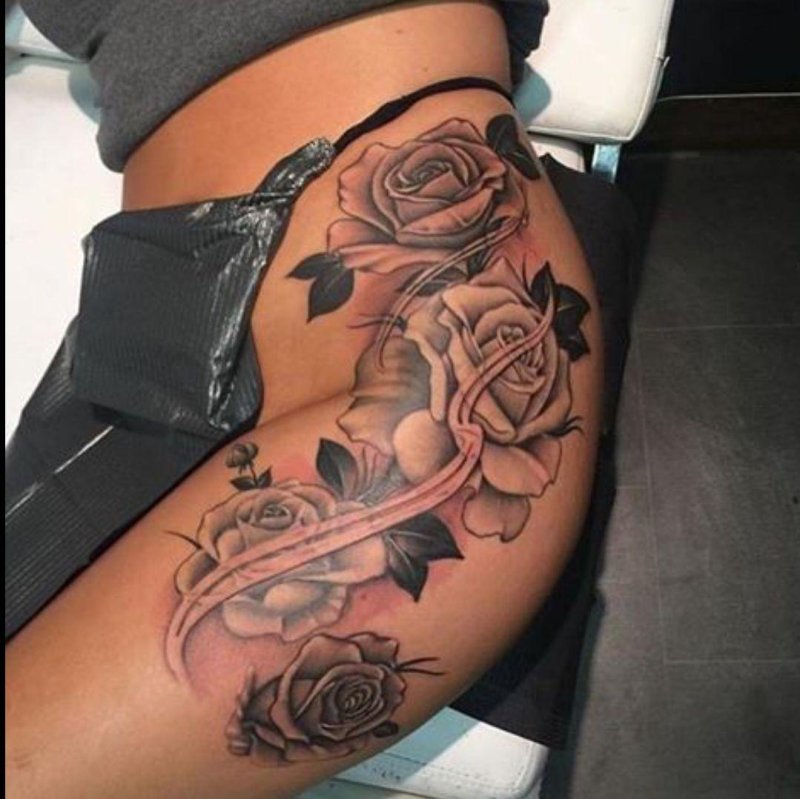 Female tattoo on the thigh