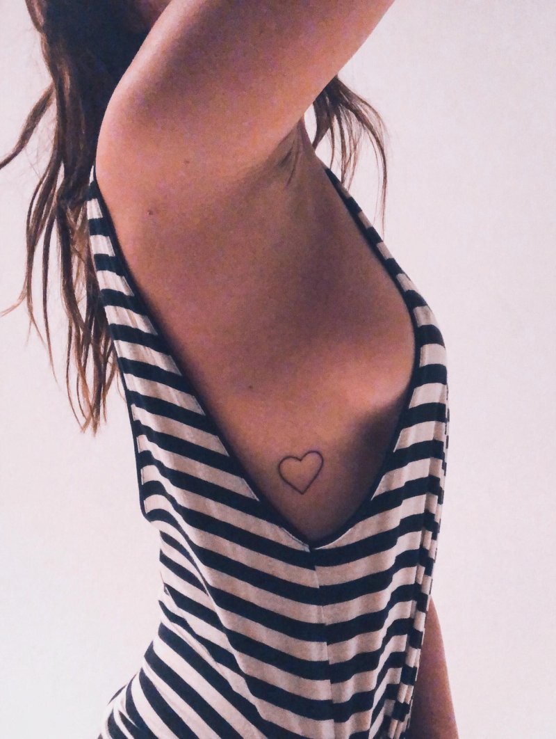 Mini tattoo heart under the sternum