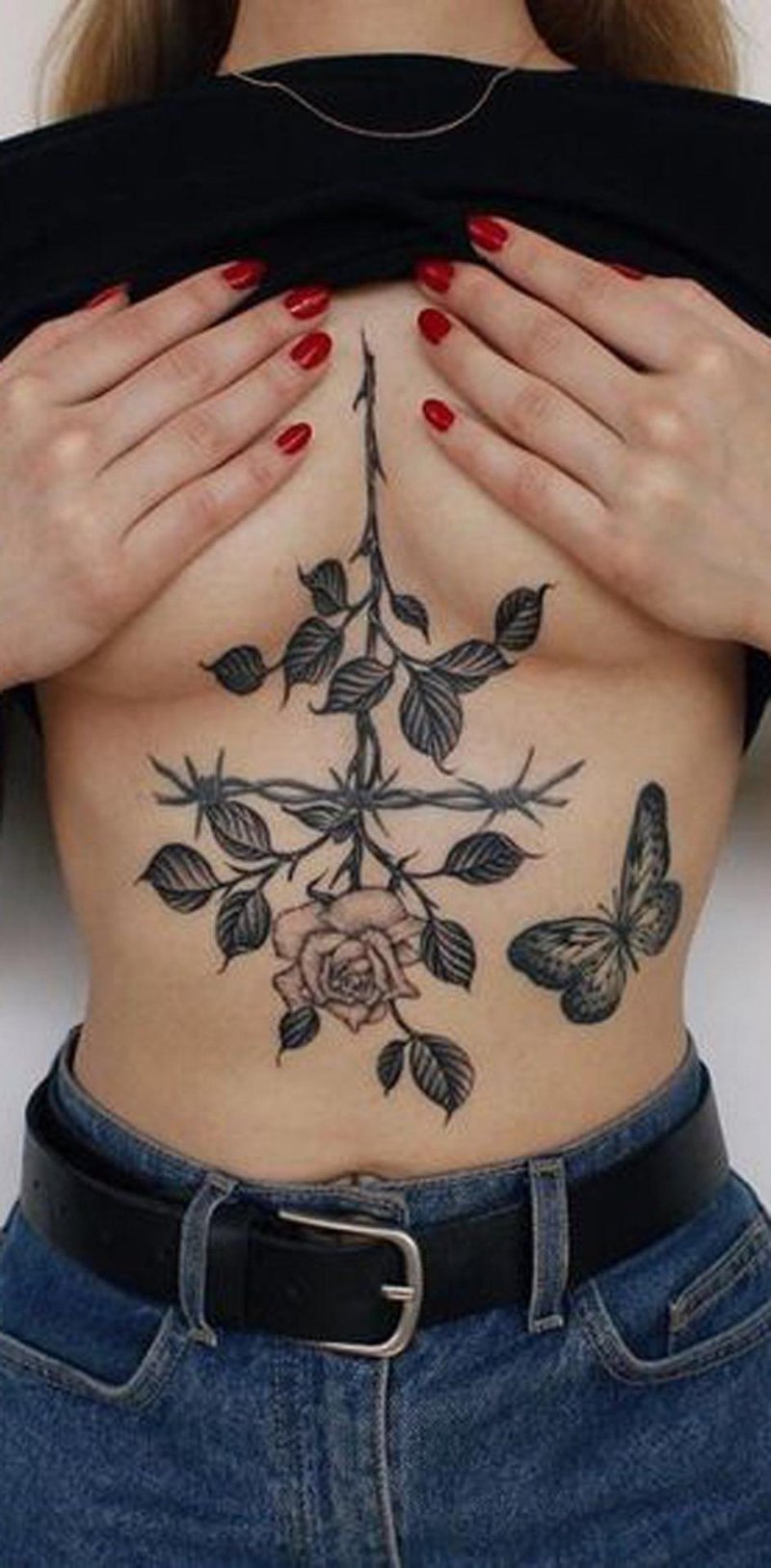 Rose tattoo under the chest