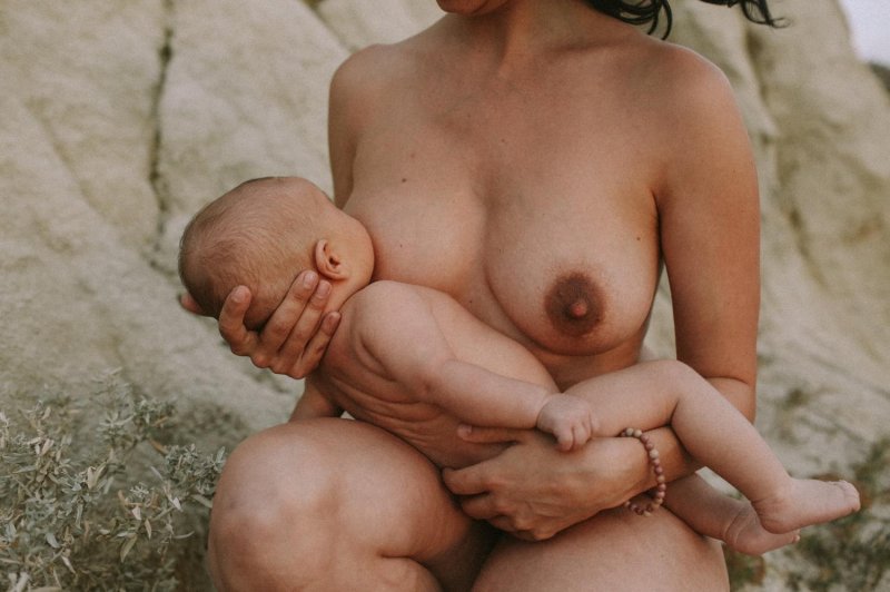 Naked girl breastfeeds