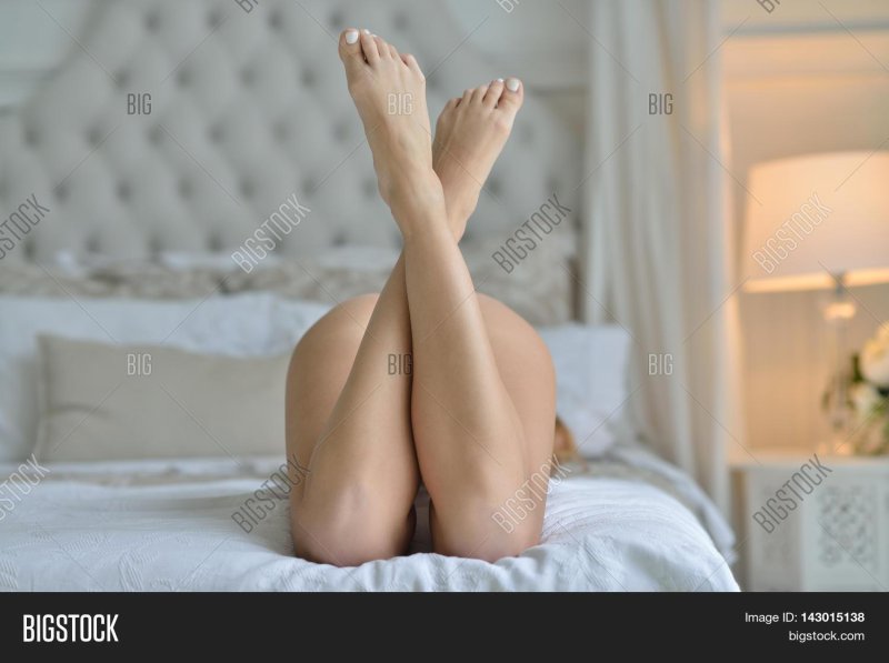 Female legs in bed