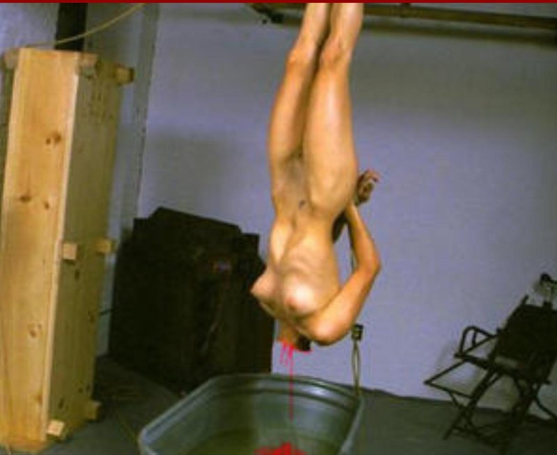 The naked woman was hung by leg